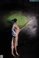 A naked woman holding a broom in her hand.